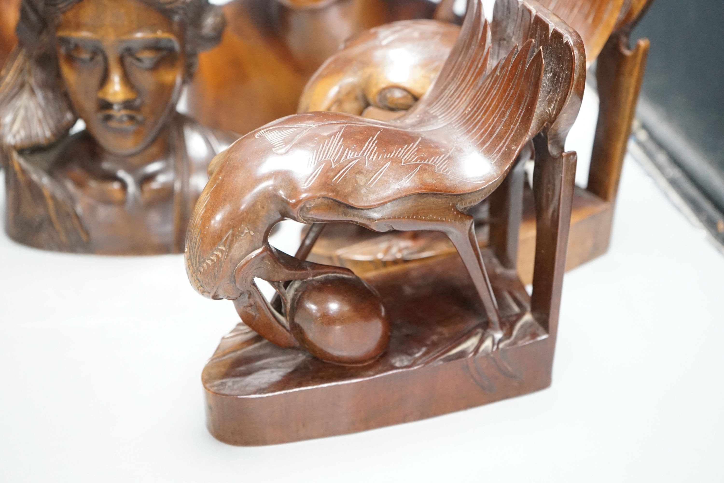 A pair of carved bird bookends ,and two pairs of carved Balinese busts